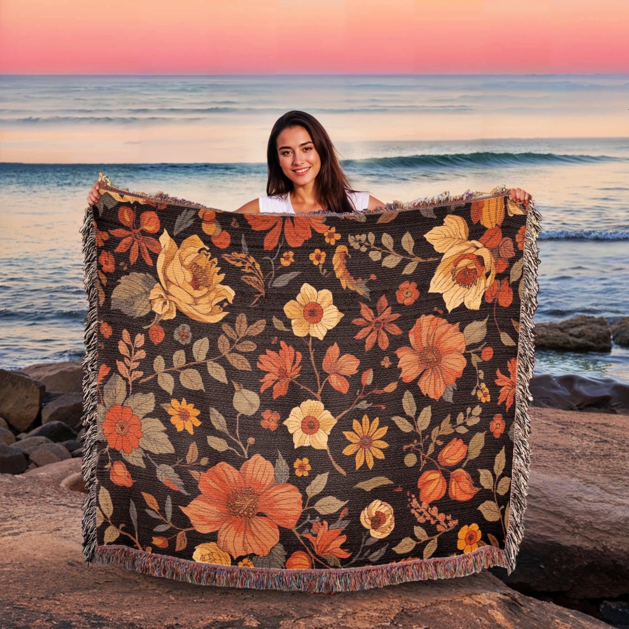 Woman holding a floral blanket with a sunset and ocean background