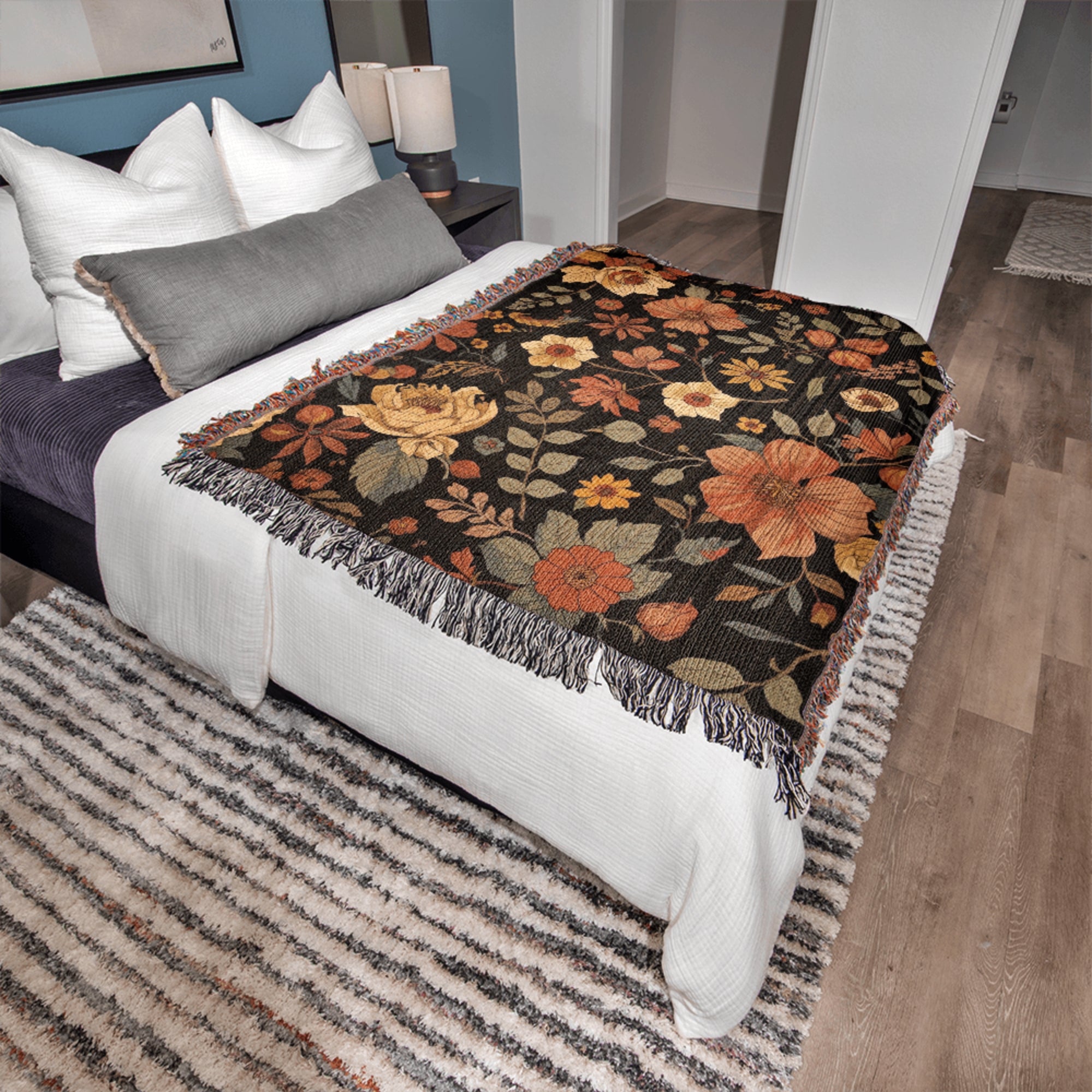 Floral patterned throw blanket on a bed in a bedroom setting
