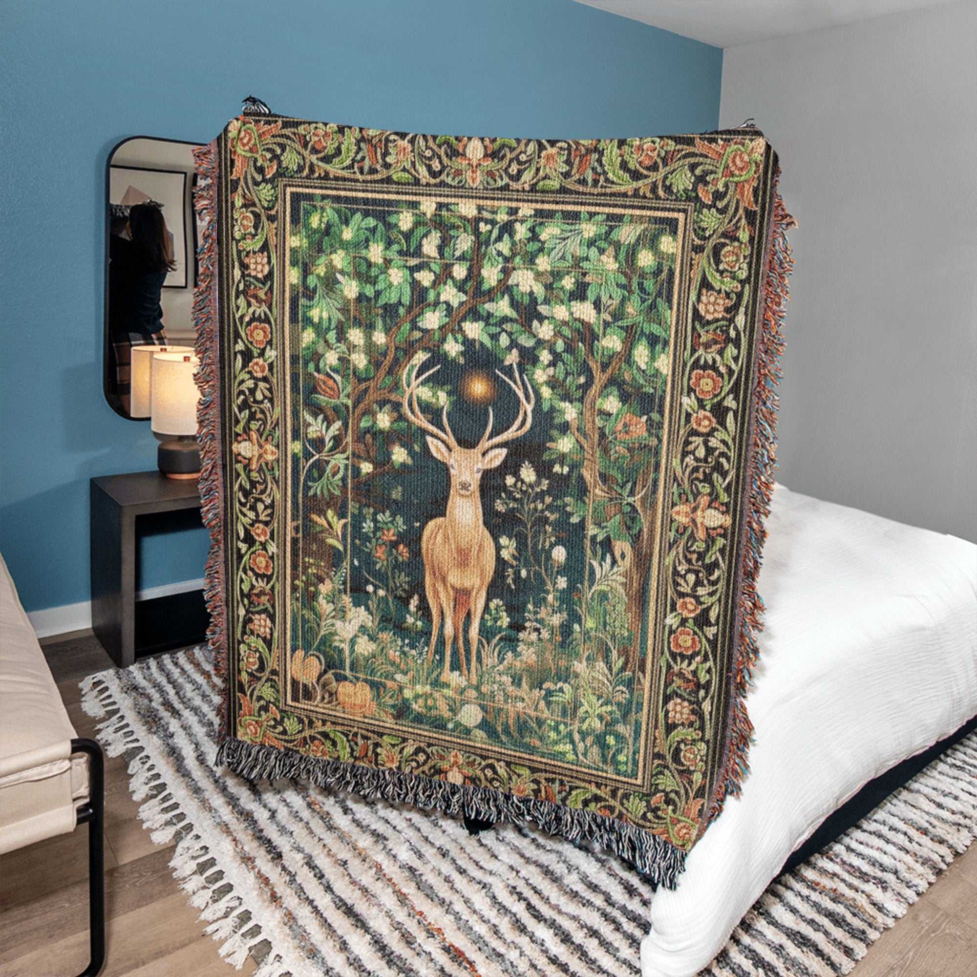 Decorative tapestry with a deer design on a bed in a bedroom setting.