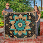 Two people holding a large floral-patterned blanket outdoors.