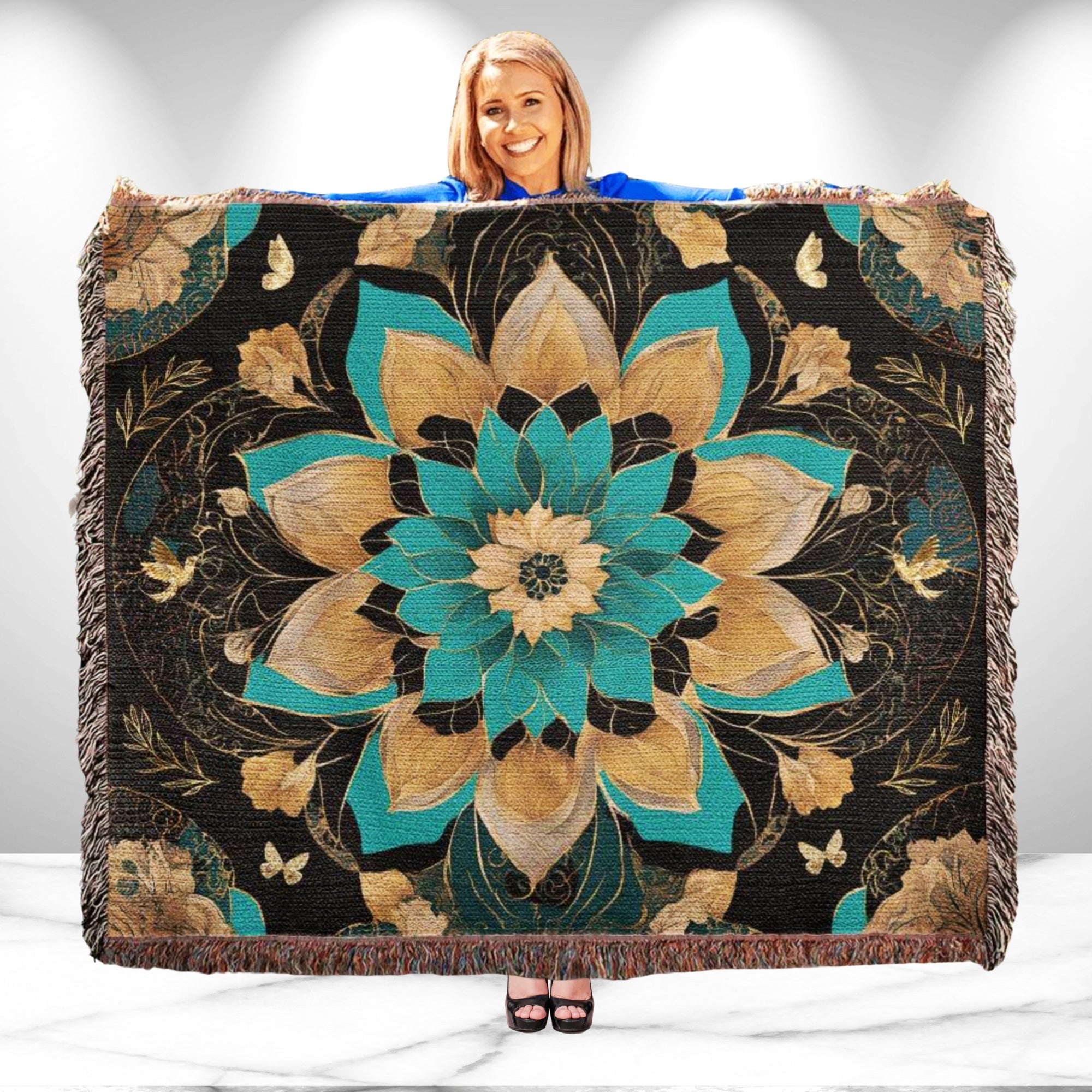 Woman holding a decorative blanket with floral patterns on a white background