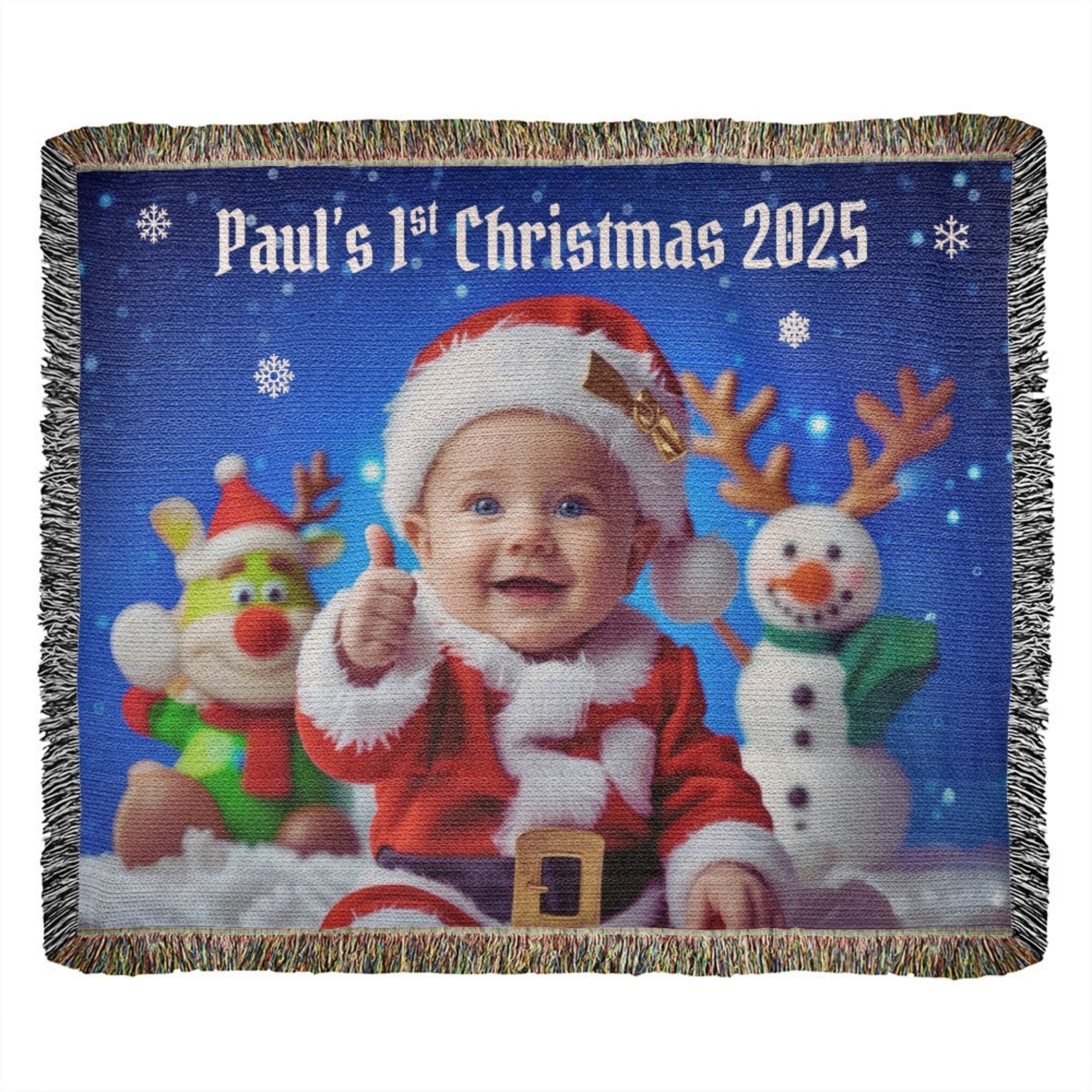 Blanket with a baby in a Santa outfit and reindeer, snowman, and text 'Paul's 1st Christmas 2025' on a blue snowy background.